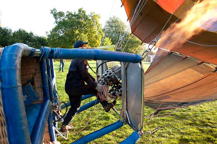 Once the hot air balloon has been filled with cold air from the special fans the pilot uses the burner to put hot air in the balloon and make it rise up. Once upright more heat is put in until the balloon is buoyant and is able to lift the weight of the passengers and travel skyward.