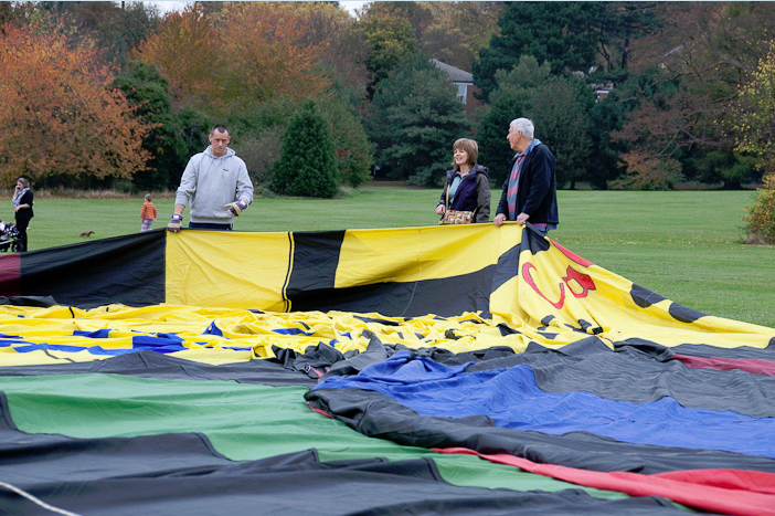 Spreading the 100 foot high balloon across the ground before filling it with hot air at the York Racecourse take off site.