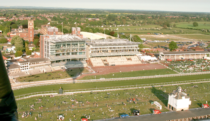 The shadow of the air balloon falls over the grandstand of the &ldquo;Knavesmire&rdquo;, York Race course as the hot air balloon ride rises up on the hot air from the balloon burners. One of the simplest forms of aviation ballooning is also one of the safest.