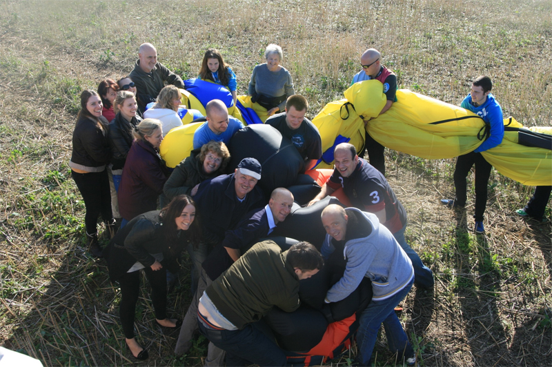 How do you get such an enormous hot air balloon that stands over 30 metres tall into a bag measuring 1 metre wide? With lots of happy passengers. It only takes about 10 minutes and as you can see our passengers enjoy this down to earth activity after floating through the skies.