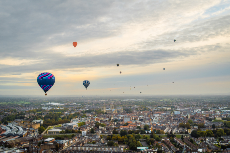 Just after take off from York Racecourse and with the wind from the south, the balloons fly over York Minster on their way across the city during the 2018 York Balloon Festival